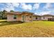Expansive backyard featuring a covered patio, perfect for outdoor entertaining and relaxation at 12 Pecan Drive Loop, Ocala, FL 34472