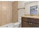 Well-lit bathroom features a tiled shower and modern vanity with a large mirror at 12 Pecan Drive Loop, Ocala, FL 34472