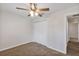 Bedroom featuring carpet, a ceiling fan, and a closet for ample storage at 12 Pecan Drive Loop, Ocala, FL 34472