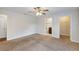 Bedroom with a ceiling fan, carpeted floor, closet and a door that leads into the bathroom at 12 Pecan Drive Loop, Ocala, FL 34472