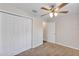 Bedroom with carpet, ceiling fan, and closet for efficient storage solutions at 12 Pecan Drive Loop, Ocala, FL 34472