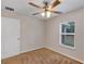 Bedroom with carpet, a ceiling fan, and a window providing outdoor views at 12 Pecan Drive Loop, Ocala, FL 34472