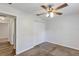 Bedroom with a ceiling fan, closet, carpeted floor and a door that leads into another room at 12 Pecan Drive Loop, Ocala, FL 34472