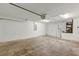 Spacious two-car garage with overhead lighting and concrete flooring at 12 Pecan Drive Loop, Ocala, FL 34472