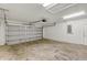 Spacious two-car garage with overhead lighting and concrete flooring at 12 Pecan Drive Loop, Ocala, FL 34472