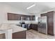 Modern kitchen with stainless steel appliances and wood-look laminate flooring at 12 Pecan Drive Loop, Ocala, FL 34472