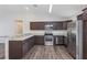 Kitchen featuring stainless steel appliances, dark wood cabinets, and a breakfast bar at 12 Pecan Drive Loop, Ocala, FL 34472