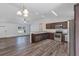 Open concept kitchen and living area with stainless steel appliances and wood flooring at 12 Pecan Drive Loop, Ocala, FL 34472