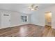 Spacious living area with wood floors, bright walls, and access to other rooms at 12 Pecan Drive Loop, Ocala, FL 34472