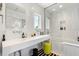 Modern bathroom with white tile, floating vanity, and a glass-enclosed shower at 1336 College Pt, Winter Park, FL 32789