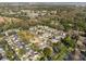 An aerial view of a well-maintained neighborhood with mature trees, winding roads, and neatly arranged homes at 1416 Creekside Cir, Winter Springs, FL 32708