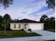 Charming one-story home with a garage under a twilight sky at 1420 Trinidad St, Deland, FL 32720