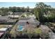 Aerial view of a neighborhood featuring a home with a screened in pool, backyard shed, manicured lawn and mature trees at 145 Roosevelt Pl, Maitland, FL 32751