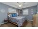 Relaxing bedroom with a bed, dresser, and windows providing natural light to the room at 145 Roosevelt Pl, Maitland, FL 32751