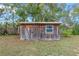 Exterior view of a well-kept wooden storage shed in the backyard at 1719 Pine Ave, Deland, FL 32724