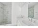 Elegant bathroom with a double sink vanity, large mirror, and a glass-enclosed shower with marble tiling at 2225 Valentine Aly, Orlando, FL 32804