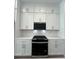 White kitchen cabinets and black appliances at 2225 Valentine Aly, Orlando, FL 32804