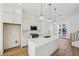Kitchen featuring white cabinets, stainless appliances, and a quartz island at 2225 Valentine Aly, Orlando, FL 32804