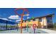 Colorful splash pad play area features various fun water features and a soft, safe surface for  at 2225 Valentine Aly, Orlando, FL 32804