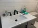 Bright bathroom featuring a white sink and a black faucet at 2500 Lee Rd # 202, Winter Park, FL 32789
