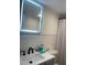 A bathroom vanity has a black faucet, white countertops and a mirror with LED lighting at 2500 Lee Rd # 202, Winter Park, FL 32789