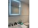 Bathroom vanity with dark faucet, light up mirror and subway tile backsplash at 2500 Lee Rd # 202, Winter Park, FL 32789