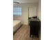 Cozy bedroom with light walls, new wood floors, and natural light at 2500 Lee Rd # 202, Winter Park, FL 32789