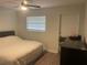 Bedroom features laminate flooring, ceiling fan, blinds on the window and black wood dresser at 2500 Lee Rd # 202, Winter Park, FL 32789