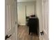 Hallway view leading into a bedroom, with a chest of drawers visible at 2500 Lee Rd # 202, Winter Park, FL 32789