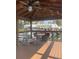 Inviting covered dock area features a rocking chair and table with chairs, ideal for enjoying waterfront views at 2500 Lee Rd # 202, Winter Park, FL 32789