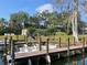 Waterfront property with a private boat dock, featuring a modern boat and scenic views of the surrounding landscape at 2500 Lee Rd # 202, Winter Park, FL 32789