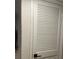 White louvered door with black hardware provides access to storage at 2500 Lee Rd # 202, Winter Park, FL 32789