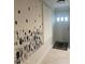 Entryway featuring white walls, ceramic tile flooring and modern art at 2500 Lee Rd # 202, Winter Park, FL 32789