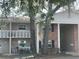 Condo exterior with brick accents, white railings, with trees adding shade and curb appeal at 2500 Lee Rd # 202, Winter Park, FL 32789