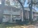 Exterior view showcasing the building's facade with balcony, pillars, and covered parking at 2500 Lee Rd # 202, Winter Park, FL 32789