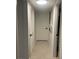 Hallway with tile floors, white doors and a closet with louvered doors at 2500 Lee Rd # 202, Winter Park, FL 32789