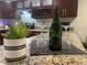 Granite kitchen island with champagne bottle, wine glasses, and succulent decor at 2500 Lee Rd # 202, Winter Park, FL 32789