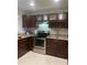 Modern kitchen featuring granite countertops, stainless appliances, and wine rack at 2500 Lee Rd # 202, Winter Park, FL 32789
