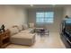 Living room with neutral furniture and tile floors at 2500 Lee Rd # 202, Winter Park, FL 32789