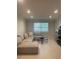 Bright living room featuring a neutral sectional sofa and tile floors at 2500 Lee Rd # 202, Winter Park, FL 32789