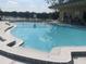 Inviting community pool surrounded by lush landscaping, providing a private and tranquil setting at 2500 Lee Rd # 202, Winter Park, FL 32789
