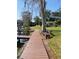 A scenic boardwalk winds through a grassy area towards the waterfront, enhanced by shaded benches at 2500 Lee Rd # 202, Winter Park, FL 32789