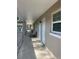 Exterior walkway with patio furniture leading to front door at 2500 Lee Rd # 202, Winter Park, FL 32789