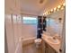 Bright bathroom featuring a window above the bathtub and a mirrored vanity at 2609 Summer Creek Dr, Kissimmee, FL 34747