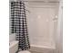 Bathroom featuring a white tiled shower and a black-and-white patterned shower curtain at 2609 Summer Creek Dr, Kissimmee, FL 34747
