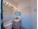Bright bathroom vanity with an illuminated mirror and a water closet at 2609 Summer Creek Dr, Kissimmee, FL 34747