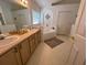 Neutral bathroom featuring a double vanity, soaking tub, tiled floor, and ample natural light at 2609 Summer Creek Dr, Kissimmee, FL 34747