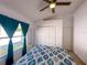 Bedroom showcasing a ceiling fan, closet, and a window with curtains at 2609 Summer Creek Dr, Kissimmee, FL 34747