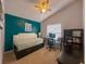 This bedroom features neutral carpeting, a vaulted ceiling and a teal accent wall at 2609 Summer Creek Dr, Kissimmee, FL 34747