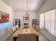 Elegant dining room with stylish chandelier and plenty of natural light at 2609 Summer Creek Dr, Kissimmee, FL 34747